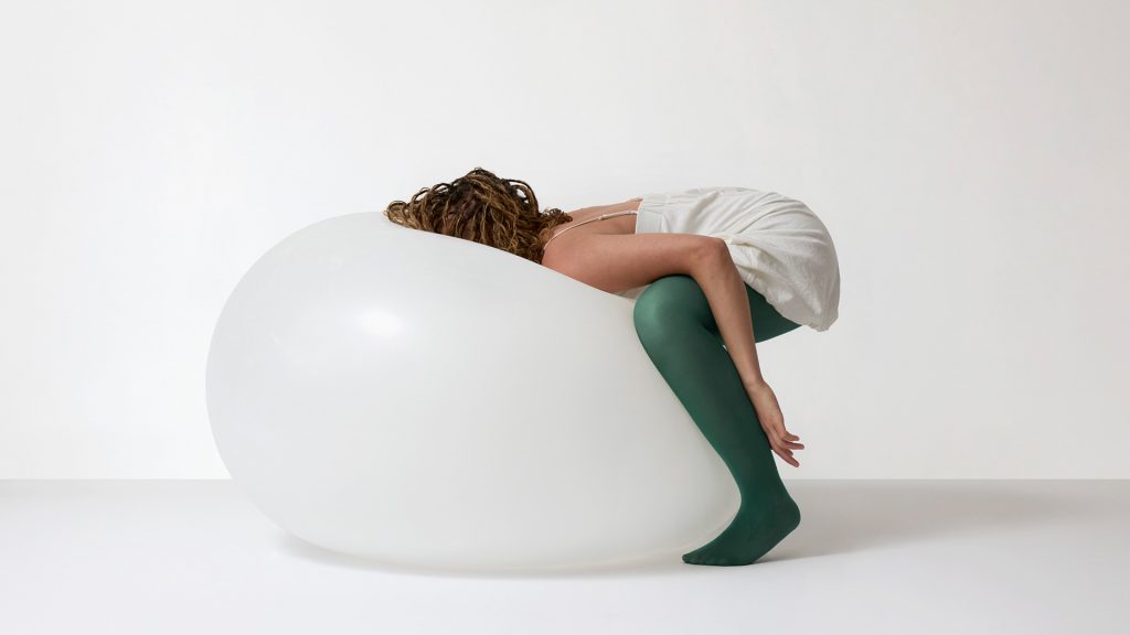 A woman laying on a weather balloon