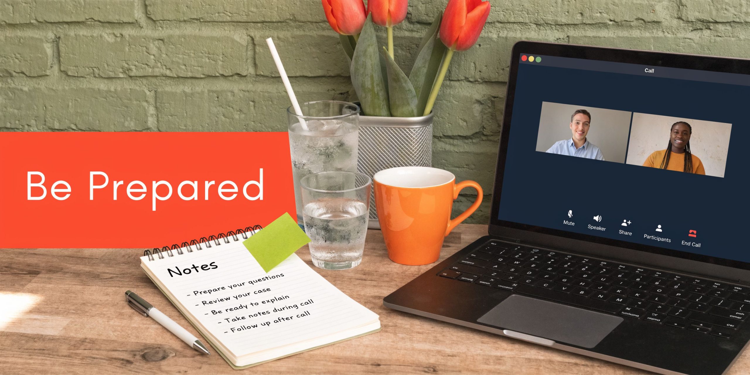 A laptop showing a video conference call alongside a notebook with preparedness notes on a wooden desk.
