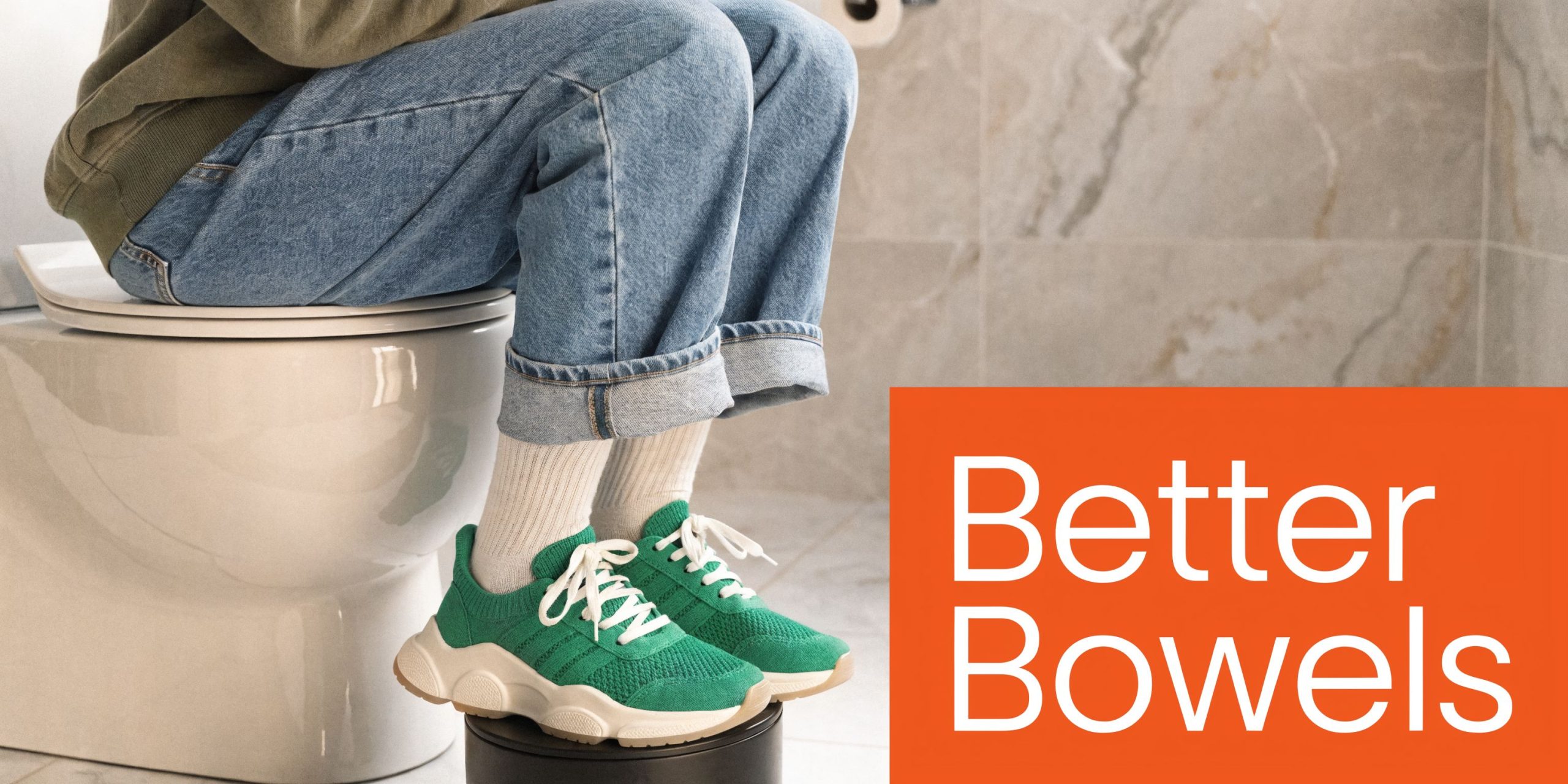 A person sitting on a toilet with their feet elevated on a stool to improve bowel health.