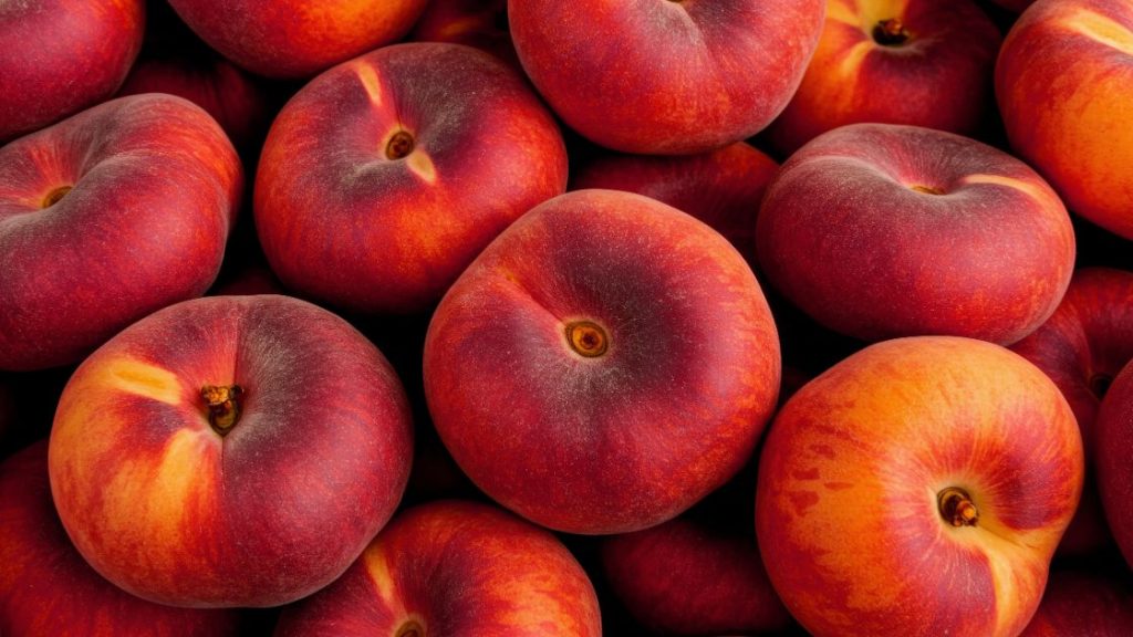 Close-up of ripe red and orange peaches, used as a lighthearted visual for anal itching cream content